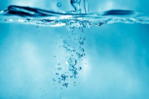 Air bubbles rising through clear water
